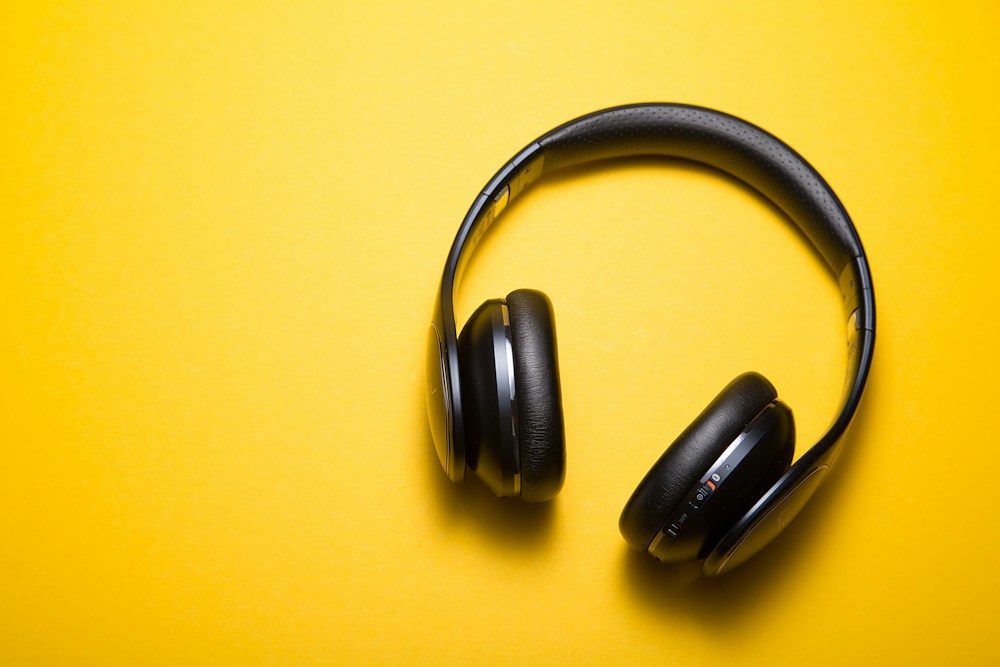 Black headphones on yellow — stock sample image
